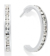 Traditions gives a sparkling boost to a simple pair of hoop earrings. A channel-set row of round-cut crystal with Swarovski elements shines within a sterling silver setting. Earrings feature a post and stud backing. Approximate diameter: 3/4 inch.