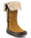 Waterproof, chill-resistant boots from The North Face® feature a cozy fuar fur collar, intricate details and soft suede.