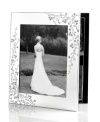 Etched with cascading florals, the silver-plated Trousseau photo album from Martha Stewart Collection presents wedding photos and other sentimental moments with fresh elegance. With velvet backing.