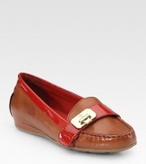 Moccasin-inspired leather with vibrant patent leather trim and a unique, hinge-adorned buckle strap. Leather and patent leather upperLeather liningRubber solePadded insoleImportedOUR FIT MODEL RECOMMENDS ordering one half size down as this style runs large. 