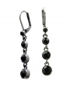 Make your look pop with bold, contrasting color. GUESS drop earrings make a dramatic statement with four graduated, round-cut, jet black crystals set in hematite tone mixed metal. Approximate drop: 1-1/2 inches.