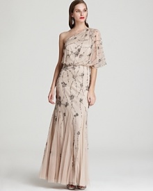 This light-as-air Adrianna Papell one-shoulder gown is splashed with sparkling sequin clusters for an ultra-glam finish.