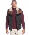 A puffer vest with a touch of cowboy style: Sean John down vest with contrast yoke and shearling-look collar and lining.