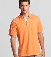 A vivid orange polo from Michael Kors with a contrast three button placket--a comfy weekend essential.