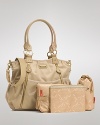 This chic, roomy satchel hides a practical secret: it's packed with on-the-go essentials for stylish mamas. By storsak.