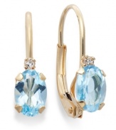 Sparkling perfection. Add a vibrant pop of color to your look with oval-cut blue topaz (9/10 ct. t.w.) and sparkling diamond accents. Crafted in a 14k gold leverback setting. Approximate drop: 3/4 inch.