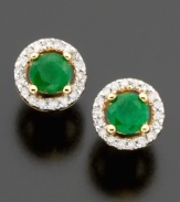 Pretty round-cut emeralds (1/2 ct. t.w.) are dressed to impress in these stud earrings featuring a beautiful setting of 14k gold & round-cut diamonds (1/10 ct. t.w.).