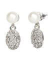 Two elegant classic combine in these eye-catching earrings by Monet. Crafted in silvertone mixed metal, oval medallions encrusted with pave crystal suspend from lustrous glass pearl. Approximate drop: 1-1/2 inches.