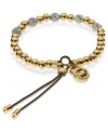 Add a little heat to your look. Michael Kors' stretchable bracelet combines gold tone beads with pave crystal fireballs. Crafted in gold tone mixed metal with an adjustable leather cord. Approximate diameter: 2-1/4 inches. Approximate width: 1/8 inch.