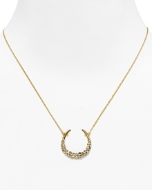 Catch good luck in this glittering 18 Kt. gold plate horseshoe, encrusted with starry Swarovski crystals. By Alexis Bittar.