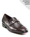 Sleek and stylish slip-on dress shoes with leather strap and buckle detail at top. Round toe. Gancini insignia etched on buckle and heel. Leather sole with slightly stacked heel.