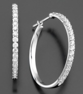 Bring on the glamour. These dazzling hoop earrings feature round-cut diamond (1-1/2 ct. t.w.) set in 14k white gold. Approximate diameter: 1 inch.