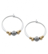 Petite hoops pop with the addition of gold tone brass and silver beads. Set in sterling silver. Approximate diameter: 3/4 inch.