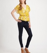 This cheery floral top offers a figure-flattering fit with cinched waist and feminine butterfly sleeves. Cross-over v-neckDropped shouldersShort butterfly sleevesDrop elasticized waistRuffle hemSilkDry cleanImportedModel shown is 5'10 (177cm) wearing US size Small.