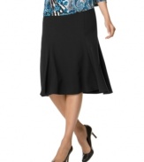 This solid stretch skirt from JM Collection flares at the hem to add volume and movement to this floaty silhouette.