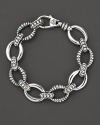 Smooth and fluted link sterling silver bracelet, with a logo lobster clasp. Designed by Lagos.