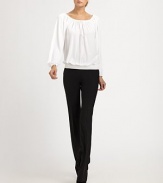 This ultra-flattering blouson style can be worn on or off the shoulder, thanks to an adjustable drawstring neckline.Drawstring portrait neckline with front self tieLong blouson sleeves with gathered cuffsSmocked, elastic hemlineViscoseDry cleanImported of Italian fabricModel shown is 5'11 (180cm) wearing US size 4. 