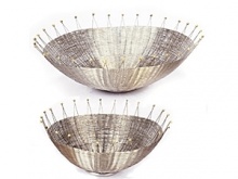 Bold, eye-catching lines capture all the grace and energy of a big splash. Designer Michael Aram uses stainless steel wire and brass welds to create his signature blend of modern material and organic form. From top: 13 Basket, 9 Basket.