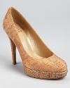 Natural cork pairs with summery raffia on these mixed material Stuart Weitzman pumps.