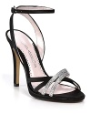 Rhinestone-strewn straps streak like sparkling comets across Caparros' elegant evening sandals.