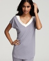 Exude laid-back chic in a soft pajama top with contrast V-neckline.