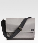 A stylish twill messenger bag for your every file and gadget.Flap-top snap closureAdjustable shoulder strapExterior slit pocketInterior laptop compartment with snap closureCotton14½W X 11H X 5½DImported