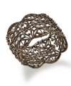 Cuff love. Sparkling crystals and an intricate openwork pattern create a dramatic statement on Style&co.'s chic cuff bracelet. Crafted in bronze. Bracelet stretches to fit wrist. Approximate length: 7-1/4 inches.