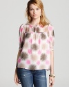 Tonal hues are highlighted by pops of pink on this effortless Milly top designed with buttons through one side for unique detail. Create a cool duet with distressed denim and give this uptown look downtown edge.