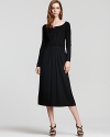 A fitted upper body meets a flowing skirt in this DKNY black dress--the perfect canvas for gleaming accessories.