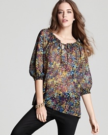 A billowy silhouette and abstract floral print bring a bohemian breeziness to this new-season Aqua top.