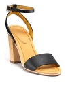 A wooden heel lends a clog-inspired feel to See by Chloé's Mora sandals.