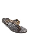 Do warm-weather style with Tory--the Thora flip flops feature leopard printed leather and a signature logo in polished gold-tone.