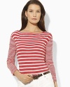 A nautical-inspired striped boat neck tee is designed with chic buttons at the shoulders for the epitome of relaxed, preppy style.