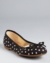 Whimsical polka dots lend a lighthearted feel to a classic pair of GUESS ballet flats.