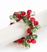 Dress up simple linens for a seasonal bash with napkin rings strung with sparkling beads. Shades of red and green complete a memorable holiday table.