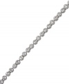 A timeless classic that can be worn alone or paired with other bracelets for a chic layered look. Swarovski's tennis bracelet features sparkling clear crystals in silver tone mixed metal. Approximate length: 7-1/2 inches.