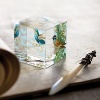 Cube shaped crystal paperweight featuring hummingbirds.