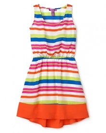 Her summer dress gets a makeover in wild neon stripes and bold colorblock.