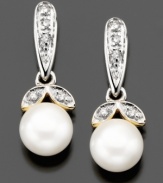 Sunny cultured freshwater pearls (6mm) are nestled between two petals of diamond accents on these beautiful drop earrings crafted in 14k gold and sterling silver. Approximate drop: 1/2 inch.