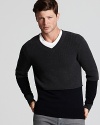 The v-neck sweater from Vince is rendered in soft merino wool, with contrast colorblock at the neck for a touch of texture.