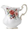 Steeped in tradition, the Rosa creamer by Royal Albert combines elaborate blooms in fine bone china. An old-world silhouette with dainty ruffled edges and bands of gold exudes old-world opulence.