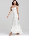 An opulently beaded bodice and sweeping skirt of three-dimensional petals lend evening opulence to this Sue Wong gown.