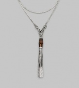 A bamboo bead and sterling silver tassels drop elegantly from a modern, snake-inspired chain with horsebit details. Bamboo Sterling silver Length around neck, about 43 Made in Italy