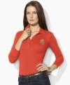 Sleek gold-toned buttons and a metallic embroidered crest lend regal elegance to Lauren by Ralph Lauren's soft cotton polo shirt.