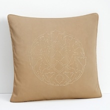 Embellished with an embroidered medallion in the center, this pillow is tailored to style in any modern setting.