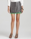 A glamorous grey DIANE von FURSTENBERG mini skirt adorned with clear sequins gets a bold color infusion from a vivid green drop hem. Marrying two of fall's chicest trends, this fabulous silhouette defines statement piece.