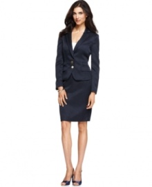 Calvin Klein's textured skirt suit features tailored details throughout, like the seamed waist, double flap pocket and low two-button closures on the jacket.