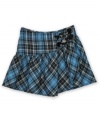 Hip. An asymmetrical cut gives a twist to the traditional plaid that decorates this stylish skirt from BCX.