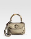 Metallic pebble-grain leather, finished with leather tassels, bamboo details and light goldtone hardware.Top handle, 5 drop Removable leather shoulder strap, 17¾ Flap with turnlock closure Inside mirror with Gucci logo One inside zip pocket Two inside open pockets Fully lined 10½W X 6½H X 4D Made in Italy