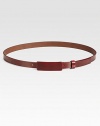 This thin leather style is finished with a small covered buckle tab.About 1 wideMade in Italy